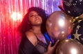 Portrait of a beautiful african american woman against twinkling background. Birthday party, nightclub and nightlife Royalty Free Stock Photo