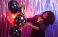Portrait of a beautiful african american woman against twinkling background. Birthday party, nightclub and nightlife Royalty Free Stock Photo