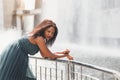 Portrait of beautiful african american woman smiling and looking away at park during sunset. Outdoor portrait of a smiling black Royalty Free Stock Photo