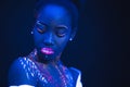 Portrait of beautiful african fashion model in neon UF light Royalty Free Stock Photo