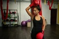 Portrait of beautiful African sports woman, attractive female boxer in black sportswear and red boxing gloves, looking to the side Royalty Free Stock Photo