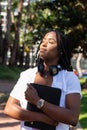 Beautiful african student getting the sun on her face Royalty Free Stock Photo