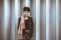 Portrait of beautiful Afro tourist female with vintage camera