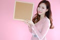 Portrait beautiful asia woman on pink background and wearing pink clothes with holding cork board, emotions action, fashion set Royalty Free Stock Photo