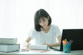 Asian lady student read a text book for prepare to examination. Person, office. Royalty Free Stock Photo