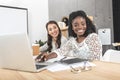 portrait of beautiful asian and african american businesswomen working on laptop together Royalty Free Stock Photo