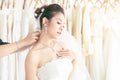 Portrait beautiful Asian bride with diamond ring in white luxury wedding dress and jewelry smiling Royalty Free Stock Photo