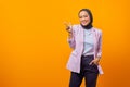 Portrait of beautiful Asian business woman pointing and looking at camera over yellow background Royalty Free Stock Photo