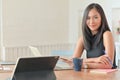 A portrait of a beautiful asian businesswoman with a laptop sitting in her comfortable office Royalty Free Stock Photo