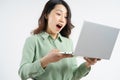 Portrait of the beautiful asian businesswoman looking at the laptop screen with a surprised look Royalty Free Stock Photo