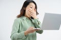 Portrait of the beautiful asian businesswoman looking at the laptop screen with a surprised look Royalty Free Stock Photo