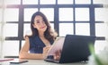 Portrait of beautiful asian freelancer woman working with a laptop in a desk at home or office. Royalty Free Stock Photo