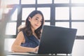 Portrait of beautiful asian freelancer woman working with a laptop in a desk at home or office. Royalty Free Stock Photo