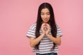 Portrait of beautiful asian girl with long brunette hair scheming evil idea and looking at camera with slyly expression