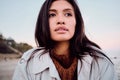 Portrait of beautiful Asian girl wistfully looking away on beach Royalty Free Stock Photo