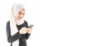 Portrait of beautiful asian muslim woman in a black hijab smiling and using mobile phone isolated over white background Royalty Free Stock Photo