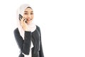 Portrait of beautiful asian muslim woman in a black hijab talking on mobile phone isolated over white background Royalty Free Stock Photo