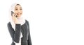 Portrait of beautiful asian muslim woman in a black hijab talking on mobile phone isolated over white background Royalty Free Stock Photo