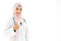 Portrait of beautiful asian muslim woman doctor smiling cheerful with thumbs up gesture isolated over white background Royalty Free Stock Photo