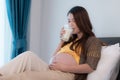 Portrait of beautiful asian pregnant woman drinking milk in bedroom Royalty Free Stock Photo