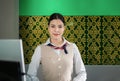 Portrait of beautiful Asian woman airport ground attendant in uniform and standing smile looking on camera at counter check in