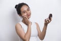 Beautiful asian woman applying powder at makeup of cosmetic  on white background Royalty Free Stock Photo