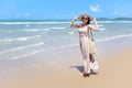 Portrait of beautiful Asian woman with big hat and sunglasses enjoy spending time on tropical sand beach blue sea, happy smiling Royalty Free Stock Photo