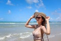 Portrait of beautiful Asian woman with big hat and sunglasses enjoy spending time on tropical sand beach blue sea, happy smiling Royalty Free Stock Photo