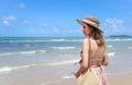Portrait of beautiful Asian woman with big hat and sunglasses enjoy spending time on tropical sand beach blue sea, happy smiling Royalty Free Stock Photo