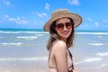 Portrait of beautiful Asian woman with big hat and sunglasses enjoy spending time on tropical sand beach blue sea, happy smiling Royalty Free Stock Photo