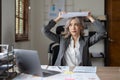 Portrait of beautiful asian woman at the desk with paperwork on her head. business overwhelmed stressed concept.