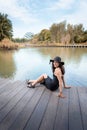 Portrait of Beautiful Asian Woman in Fashion Black Dress With Her Hat at Garden By The Bay,  Beauty and Fashion Concept Royalty Free Stock Photo