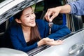 Portrait of a beautiful Asian woman getting a new car, smiling, happy Royalty Free Stock Photo