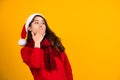 Portrait of beautiful asian woman model wearing santa hat isolated over yellow background. She was surprised and excited Royalty Free Stock Photo