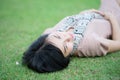 Portrait of beautiful Asian woman in the park relaxing outdoor with happy smile