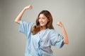 Portrait of a beautiful Asian woman in patient gown raised her arms to cheer up and feel happy after better from illness treatment Royalty Free Stock Photo