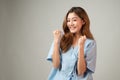 Portrait of a beautiful Asian woman in patient gown raised her arms to cheer up and feel happy after better from illness treatment