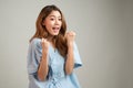 Portrait of a beautiful Asian woman in patient gown raised her arms to cheer up and feel lucky after annual check up with good Royalty Free Stock Photo