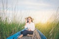 Portrait of beautiful Asian woman sitting on fishing boat, enjo Royalty Free Stock Photo