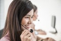 Portrait of beautiful asian woman sitting smiling and wearing headset working customer support and assistance service call center Royalty Free Stock Photo