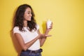 Beautiful asian woman smiling while prresenting a glass of milk Royalty Free Stock Photo