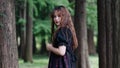 Portrait of beautiful Asian woman standing in summer forest, Chinese girl in vintage black dress looking at camera Royalty Free Stock Photo