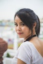 Portrait beautiful Asian woman in a white T-shirt looking at a camera at the Wat Arun temple while traveling in Thailand Royalty Free Stock Photo