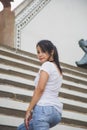 Portrait beautiful Asian woman in a white T-shirt looking at a camera at the Wat Arun temple while traveling in Thailand Royalty Free Stock Photo