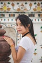 Portrait beautiful Asian woman in a white T-shirt looking at a camera at the Wat Arun temple while traveling in Thailand Royalty Free Stock Photo