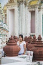 Portrait beautiful Asian woman in a white T-shirt looking at a camera at the Wat Arun temple while traveling in Thailand Royalty Free Stock Photo