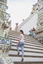 Portrait beautiful Asian woman in a white T-shirt looking at a camera at the Wat Arun temple while traveling in Thailand Royalty Free Stock Photo