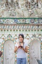 Portrait beautiful Asian woman in a white T-shirt taking a photo looking at a camera at the wat Arun temple while traveling in Royalty Free Stock Photo