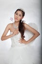 Portrait beautiful asian woman in white wedding dress with fairy scepter with angel wings Royalty Free Stock Photo