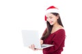 Portrait of beautiful asian young woman in santa hat using laptop Royalty Free Stock Photo